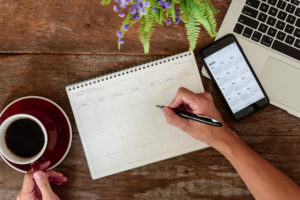 SEPTEMBER 17, 2018: Working table top with organizer for monthly planing with Iphone 8 plus use calendar application with year 2019
